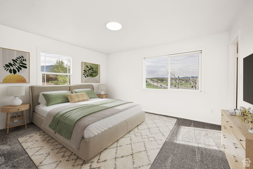 Room featuring three windows, a ceiling-mounted light fixture, and carpet flooring