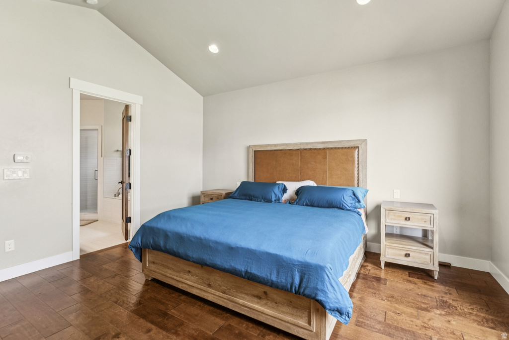 Bedroom with lofted ceiling, hardwood / wood-style flooring, recessed lighting, and ensuite bath