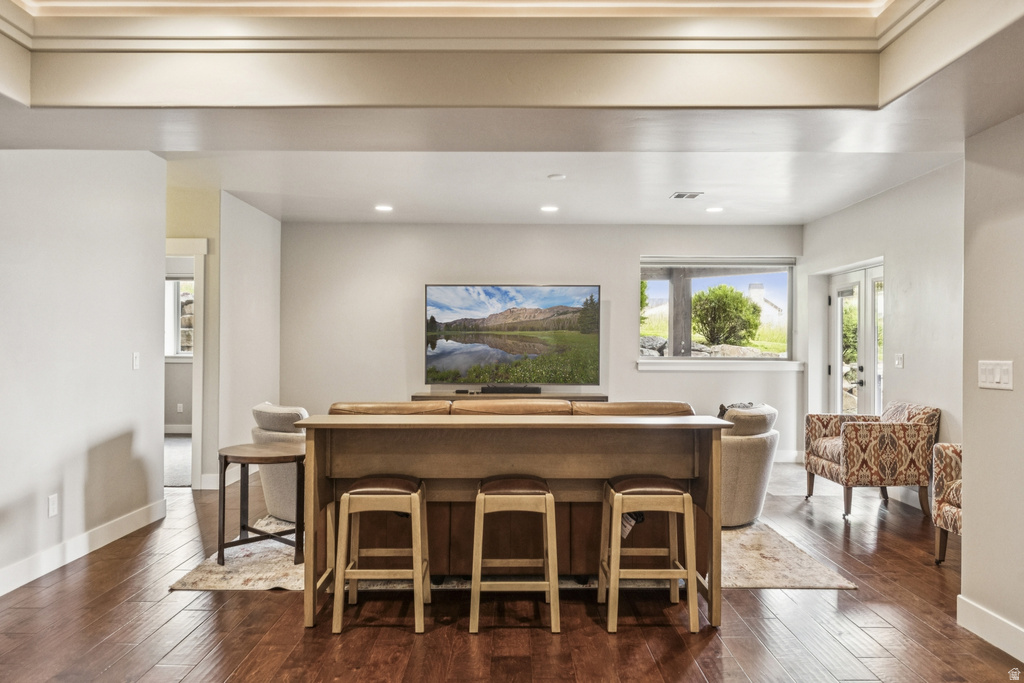 Bar with dark wood finished floors and recessed lighting