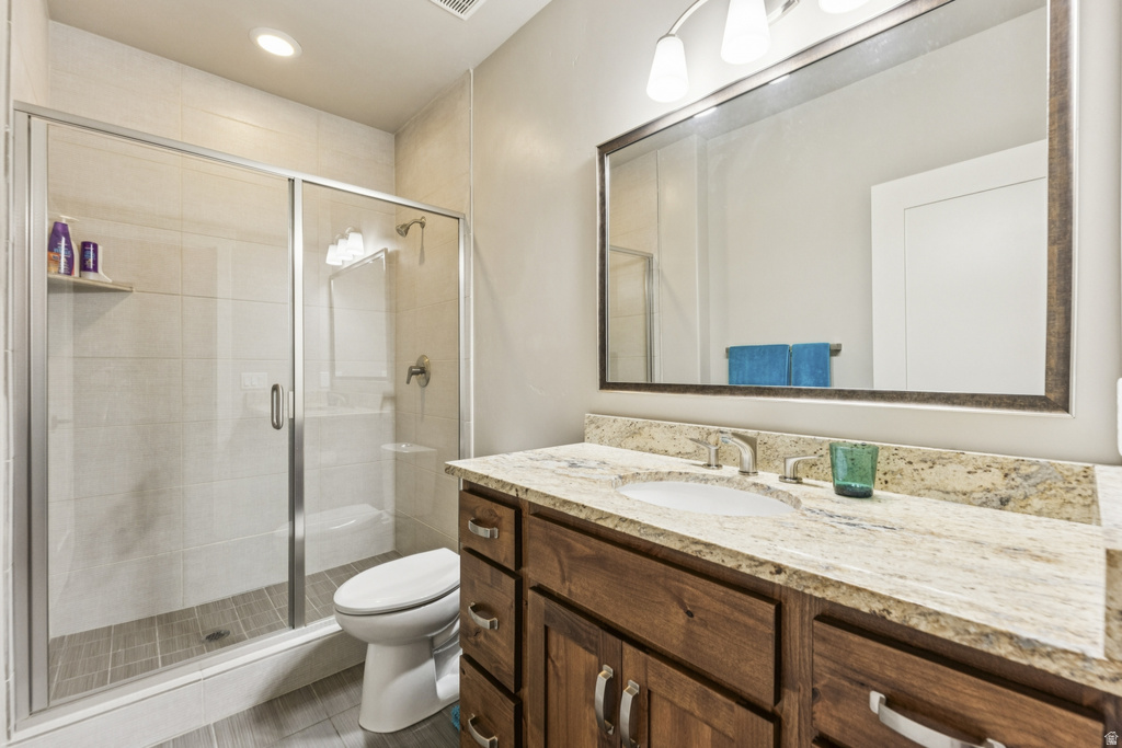 Bathroom with vanity, a shower stall, and recessed lighting