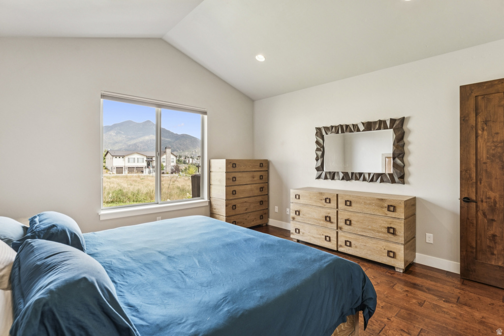 Bedroom with dark wood-style floors, a mountain view, and recessed lighting