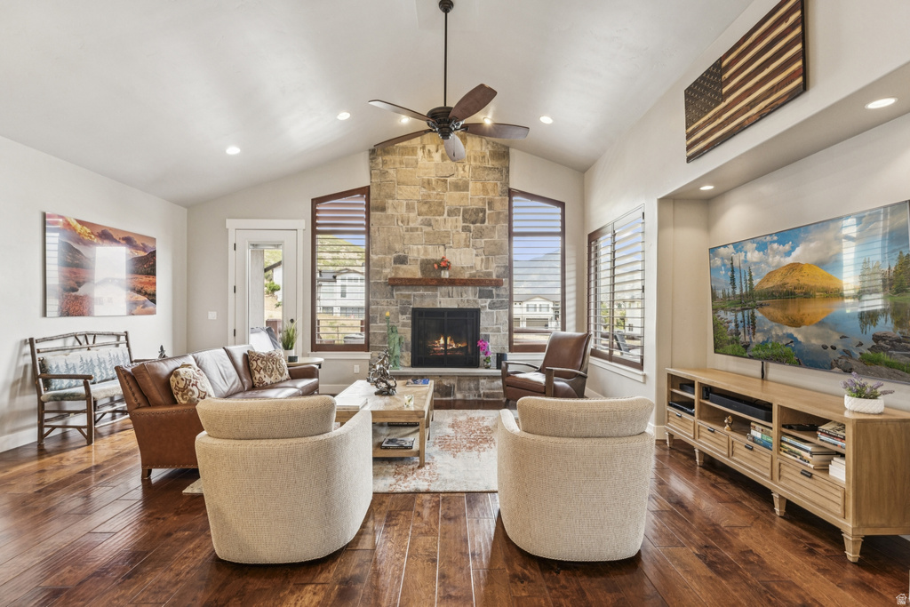 Living area featuring dark wood-style floors, a stone fireplace, plenty of natural light, ceiling fan, and recessed lighting
