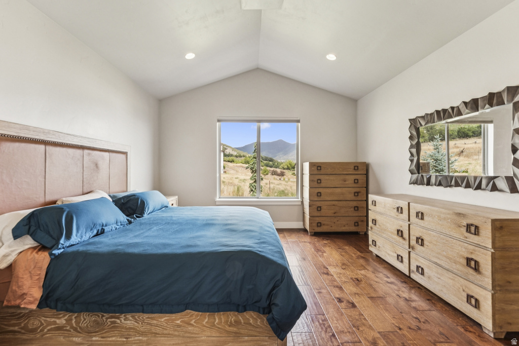 Bedroom featuring a mountain view, dark wood finished floors, and recessed lighting