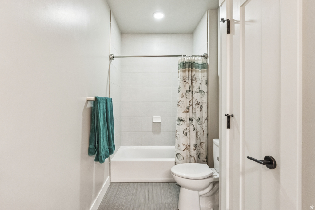 Full bathroom with shower / bathtub combination with curtain and recessed lighting