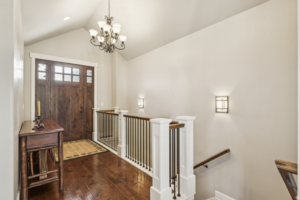 Entrance foyer featuring dark wood-style floors and hanging lights