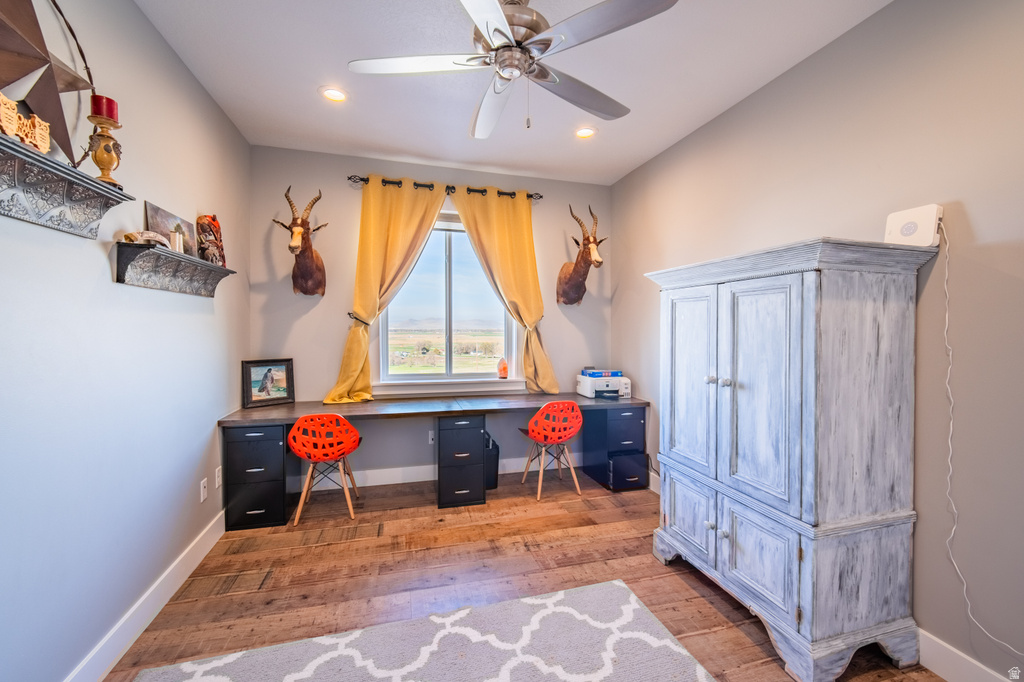 Home office with light wood-style flooring, ceiling fan, and recessed lighting