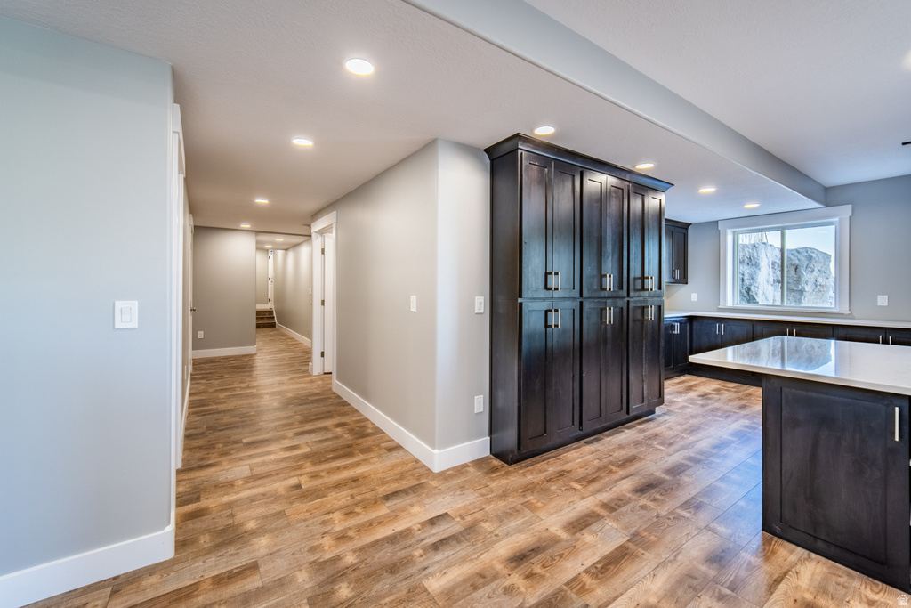 Kitchen featuring light wood-style flooring, recessed lighting, and light stone countertops