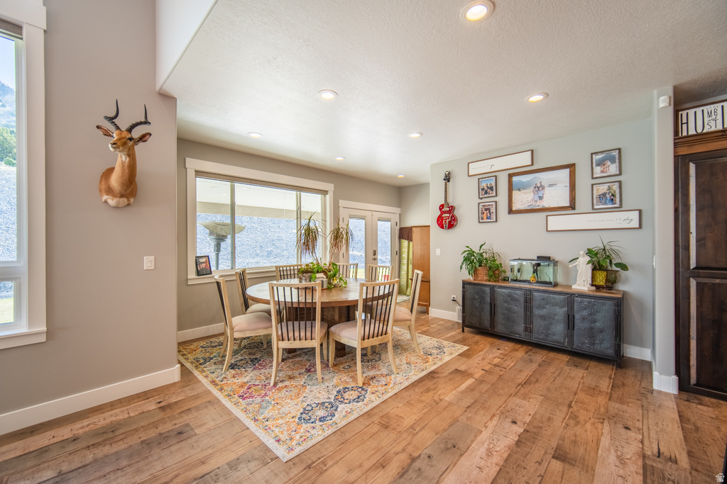 Dining area featuring recessed lighting, light wood-style floors, and french doors