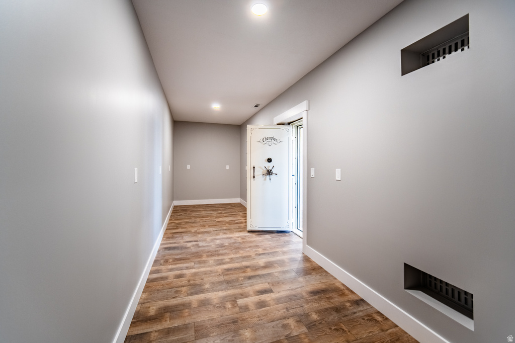 Hall featuring wood finished floors and recessed lighting