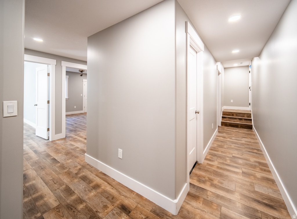Hallway featuring light wood-type flooring and recessed lighting