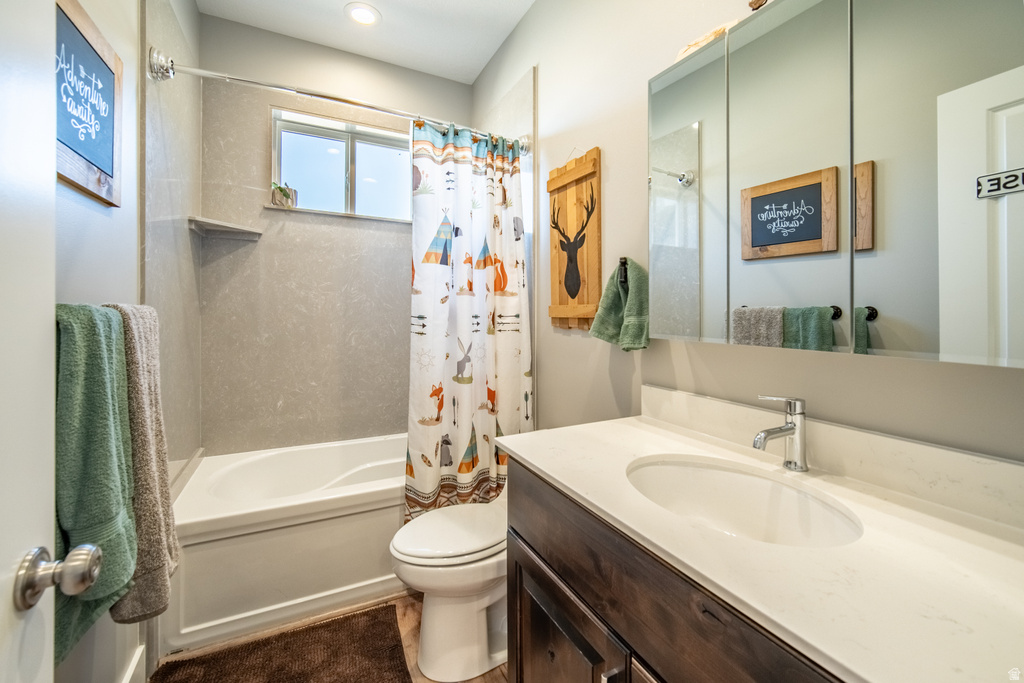 Bathroom with vanity and shower / bathtub combination with curtain