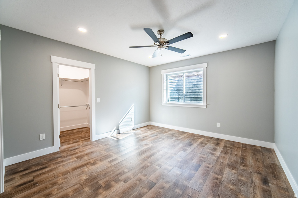 Spare room with dark wood finished floors, ceiling fan, and recessed lighting