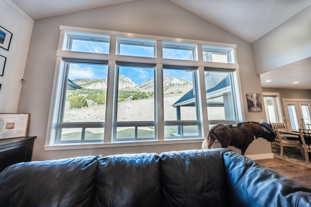 Living area featuring vaulted ceiling, plenty of natural light, and wood finished floors