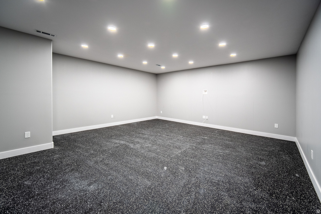 Unfurnished room featuring dark carpet and recessed lighting