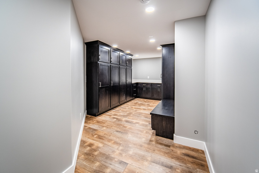 Laundry area featuring light wood-style floors and recessed lighting