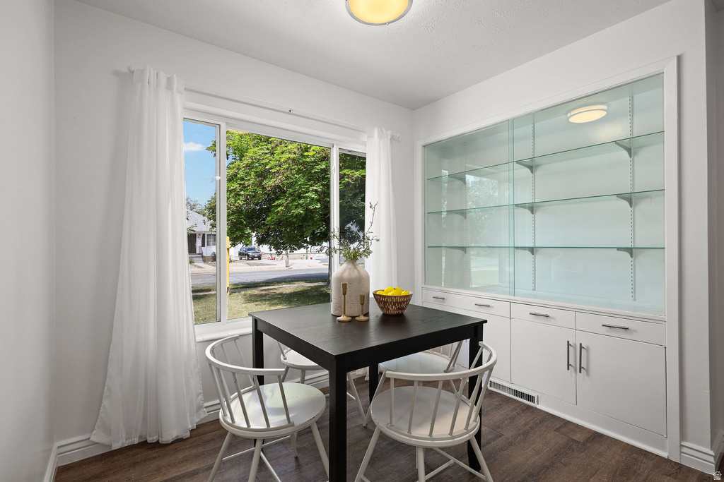Built-in display cabinetry with glass shelving and integrated lighting