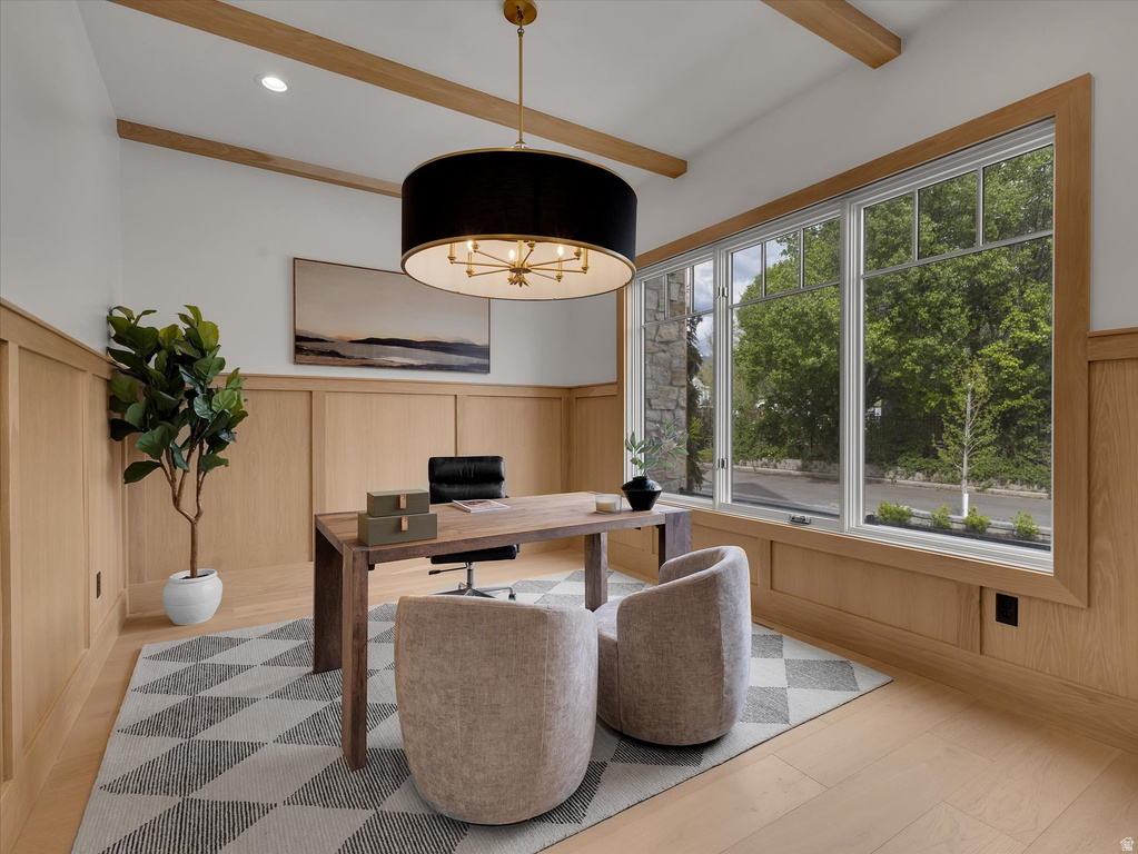 Office area with a wainscoted wall, beamed ceiling, and a decorative wall