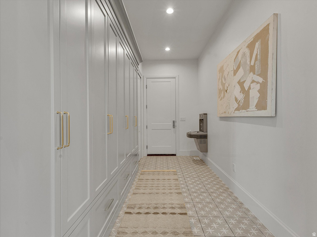 Corridor with baseboards and recessed lighting