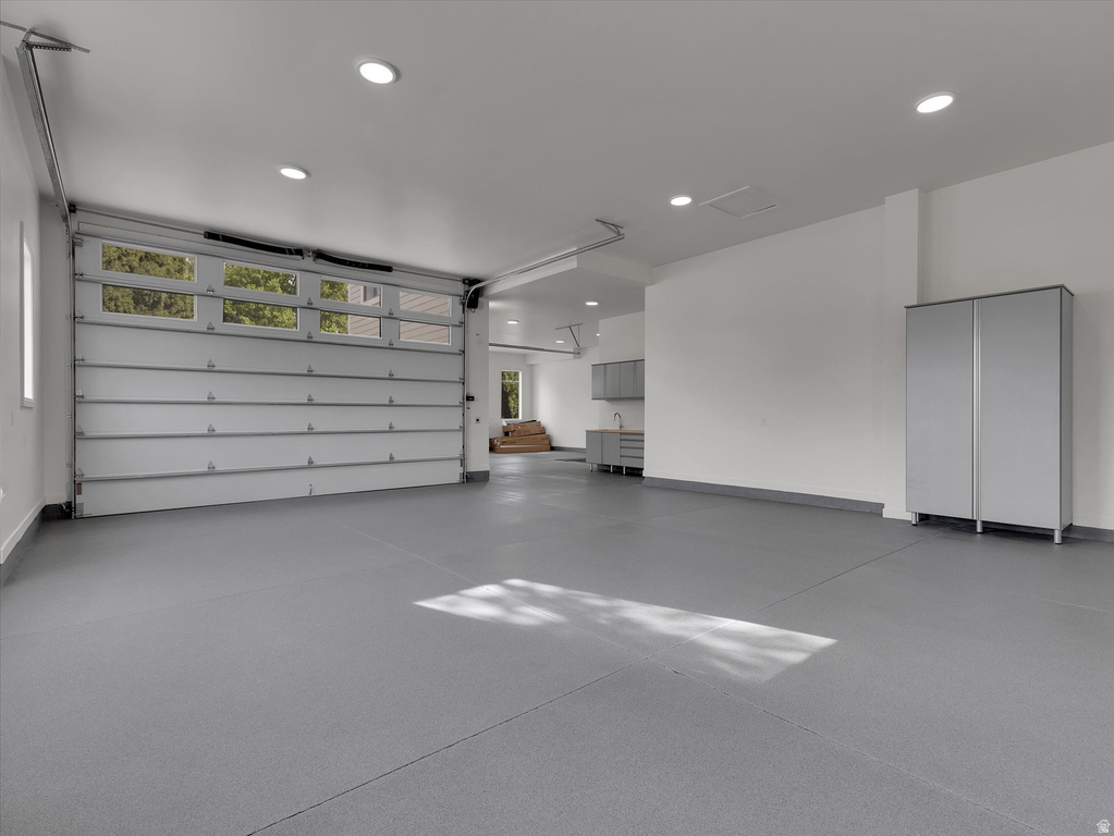 Garage featuring recessed lighting and baseboards