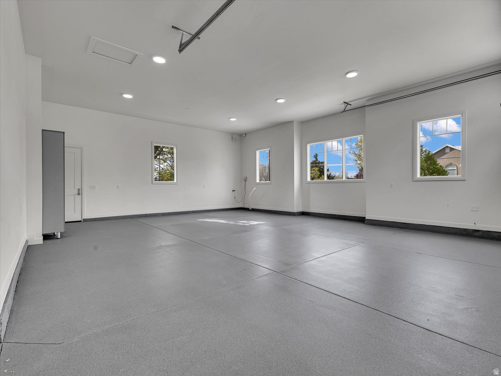 Garage featuring baseboards and recessed lighting
