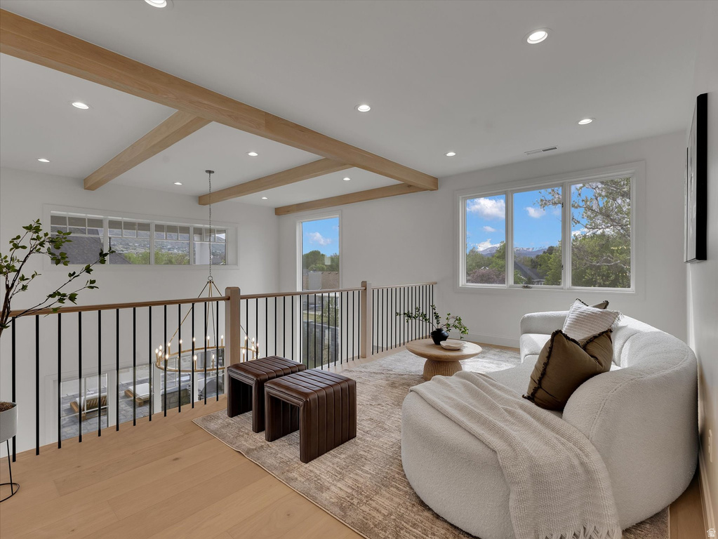 Sitting room with beam ceiling, light wood-type flooring, and recessed lighting