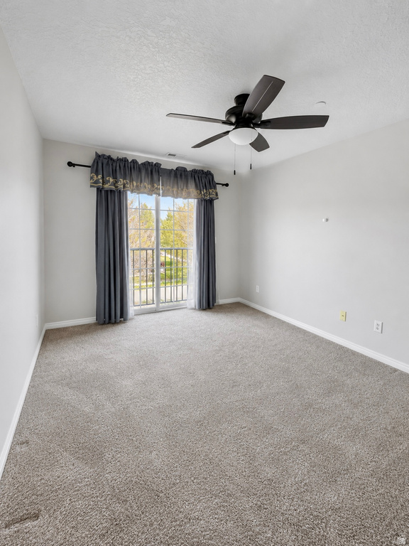 Room featuring neutral-toned carpeting, light gray wall paint, and white trim