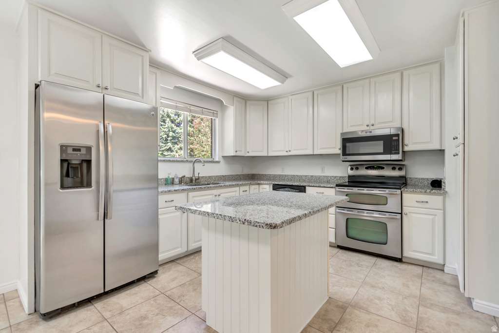 Kitchen featuring light-toned cabinetry, granite countertops, and stainless steel appliances