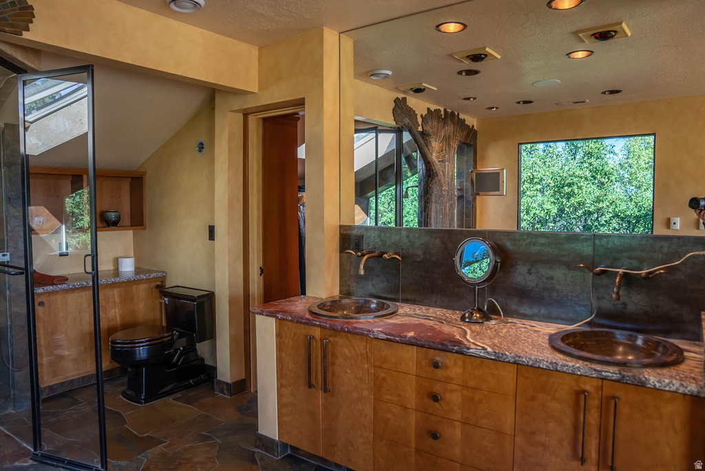Dual vanity with integrated bronze sinks and unique branch-style bronze faucets
