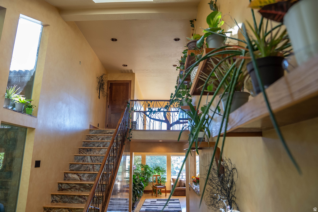 Interior staircase featuring stone-finish treads and a wrought-iron railing with wood detailing