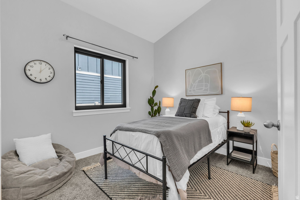 Interior room featuring a window with black trim, gray walls, and carpet flooring
