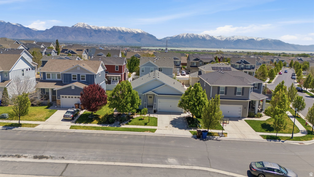 Residential neighborhood featuring diverse architectural styles, tree-lined streets, and distant mountain scenery