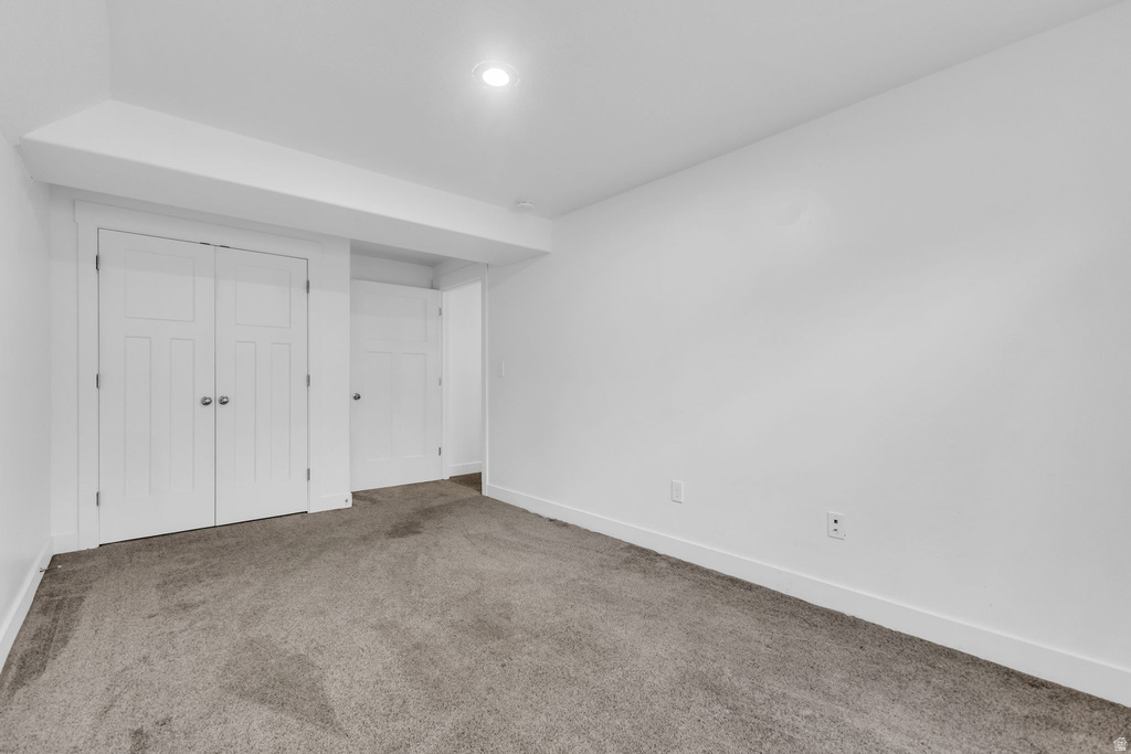 Room featuring neutral gray carpet, white walls, and recessed lighting