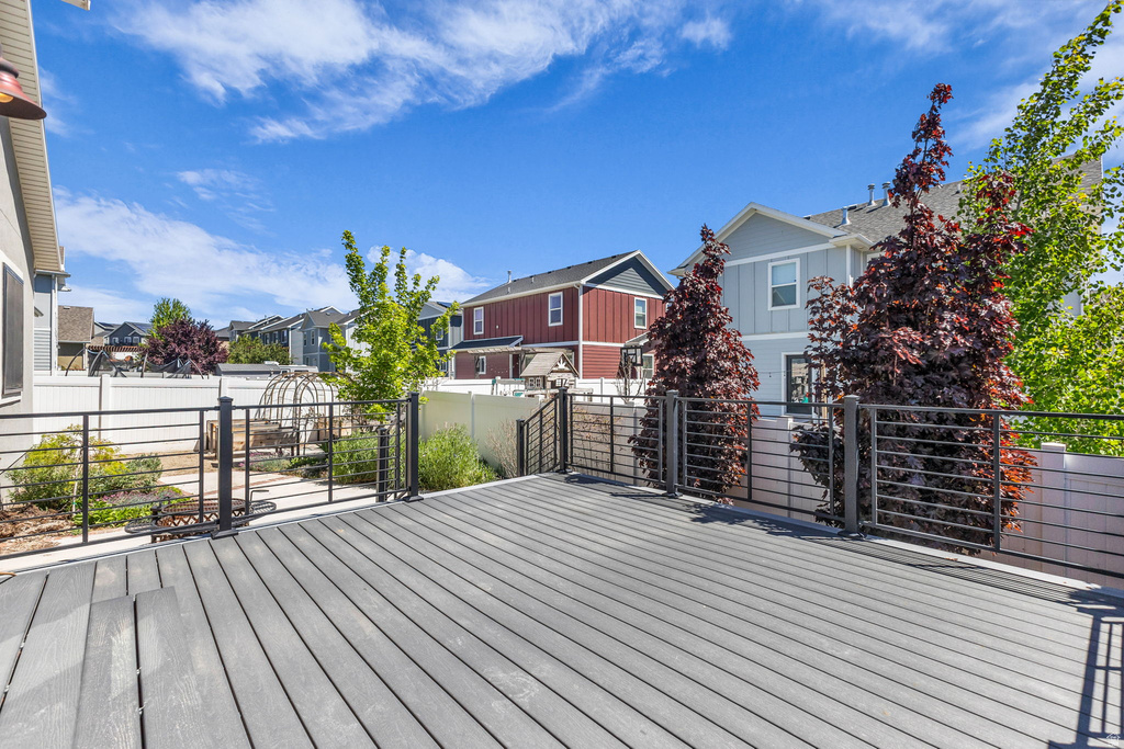 Spacious multi-level deck featuring composite decking and black metal railings with horizontal infill