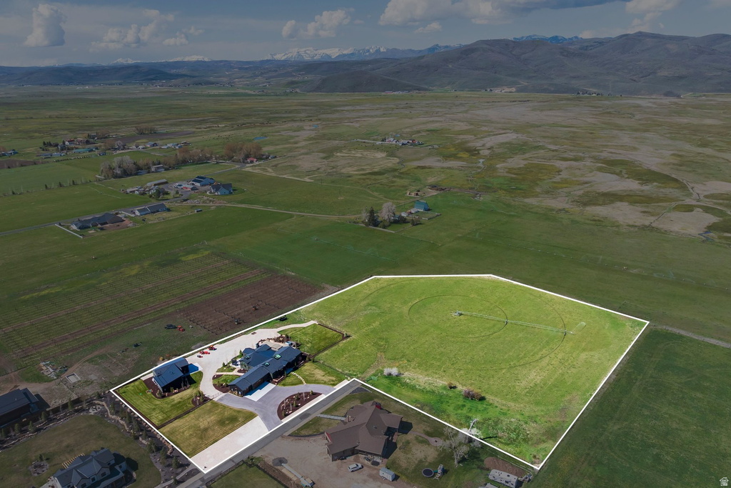Expansive property featuring a modern ranch-style residence, a circular driveway, and an additional separate structure