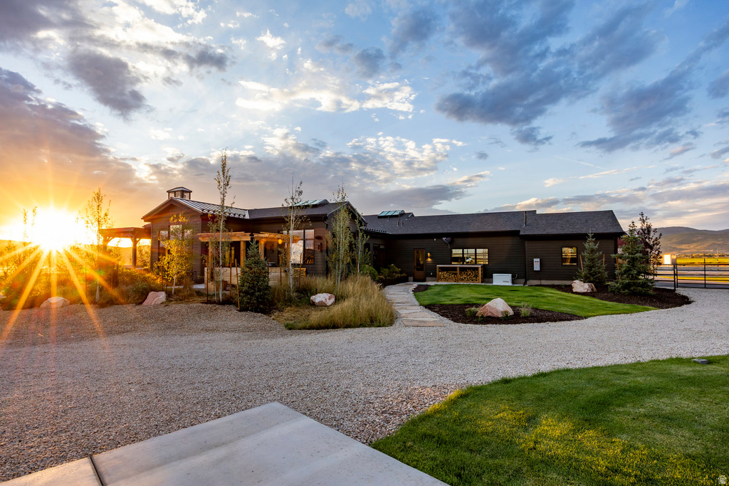 Contemporary exterior with dark siding and a prominent cupola