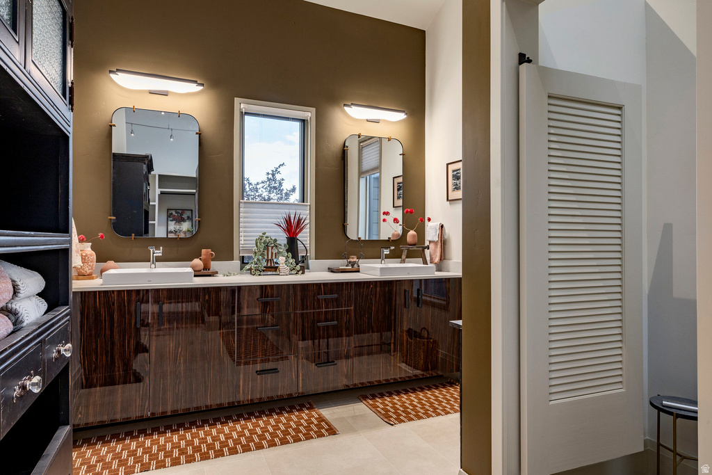 Double vanity featuring two rectangular vessel sinks, extensive counter space, and dark wood-grain cabinetry