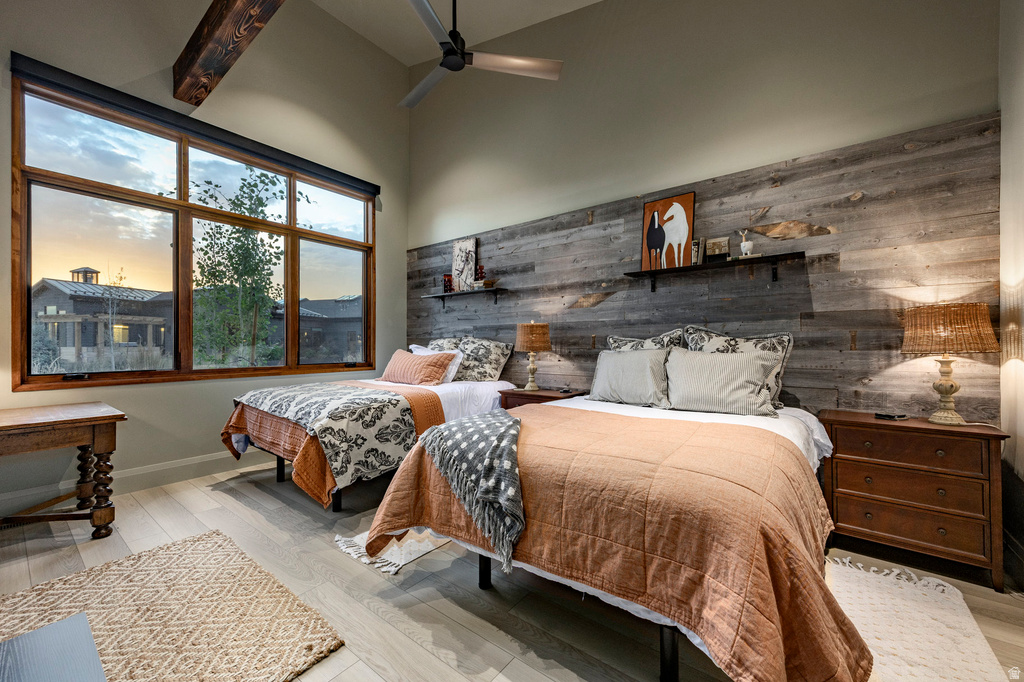 Room featuring a prominent wood plank accent wall and large multi-pane window