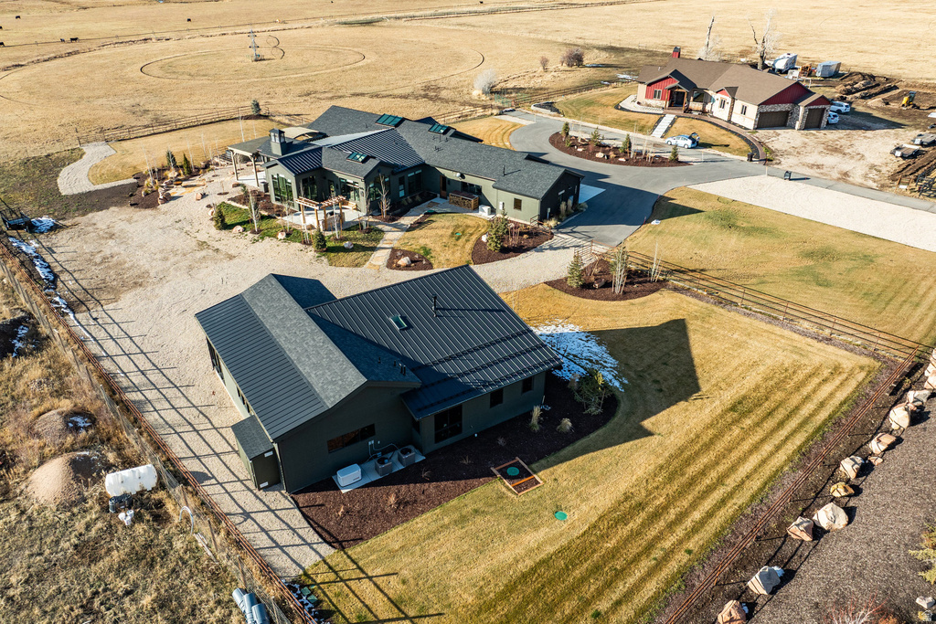 Expansive property featuring a modern residence, a detached auxiliary building, and a separate structure with an attached garage
