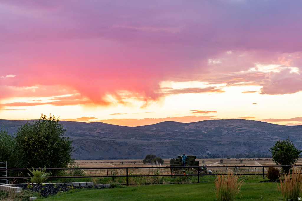 Expansive rural landscape featuring distant mountains and open fields