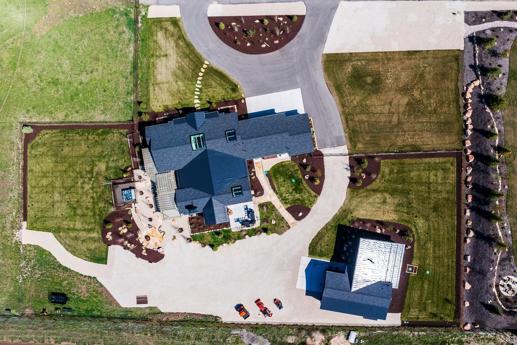 Expansive property featuring multiple structures, extensive hardscaping, manicured lawns, a circular driveway, and an outdoor hot tub