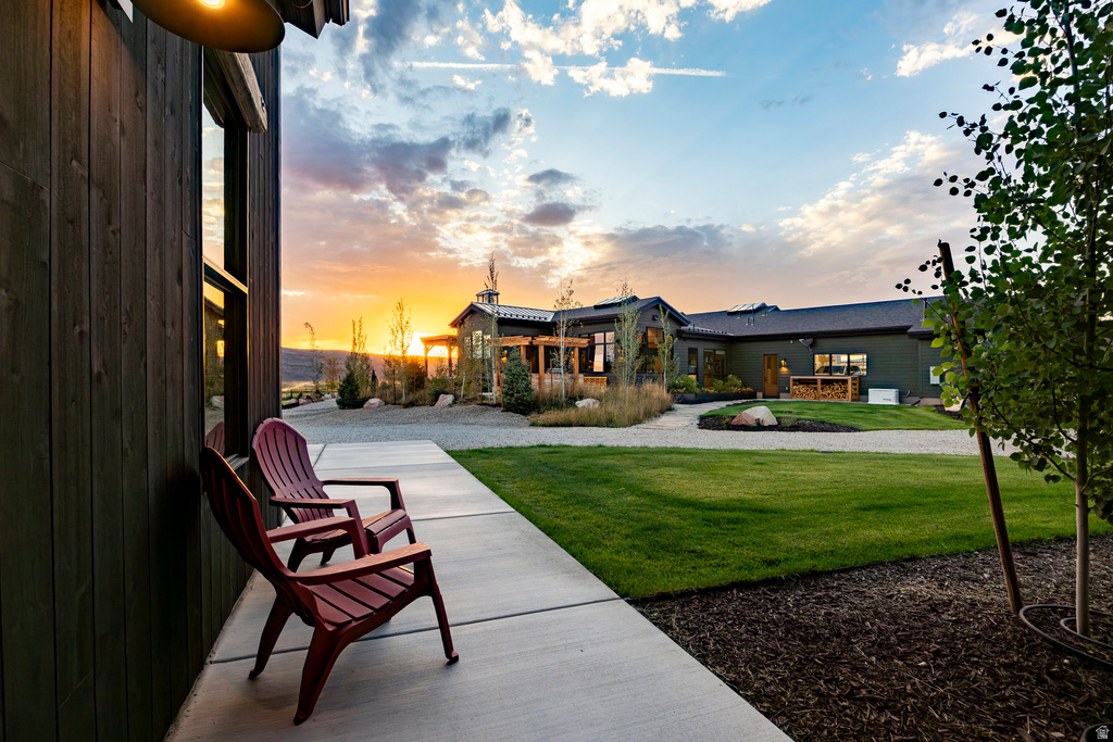 Expansive exterior featuring dark vertical wood siding and large windows