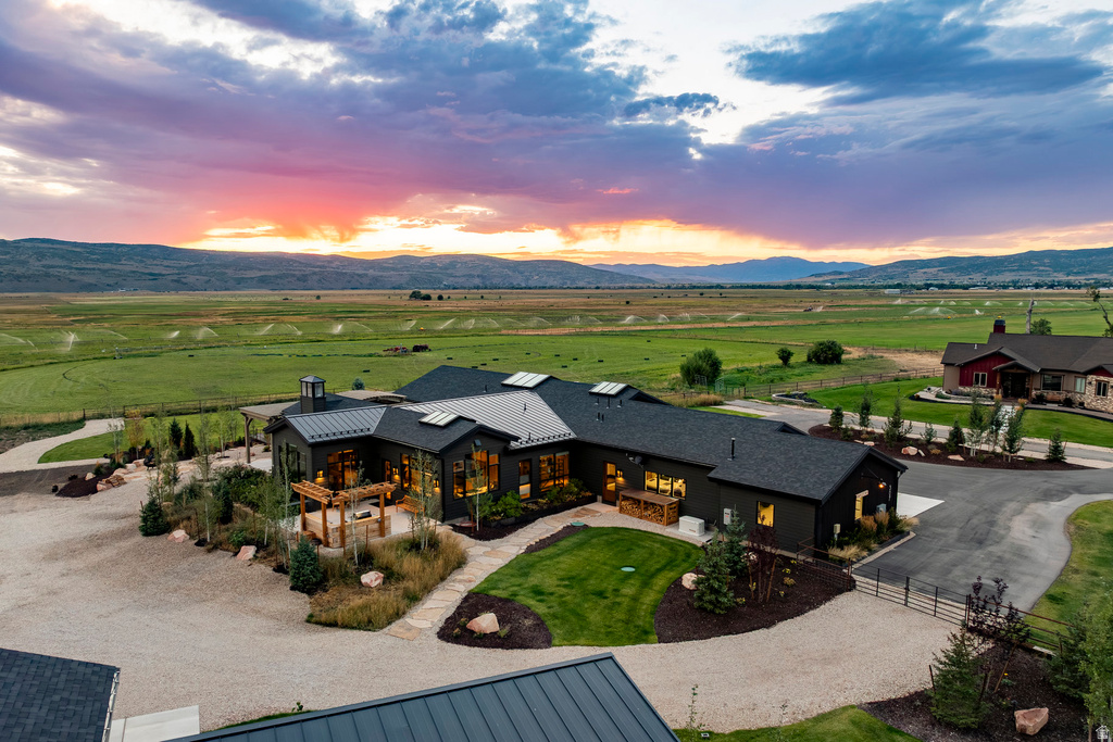 Modern farmhouse architecture featuring dark siding, a multi-gabled roofline, and extensive window placement