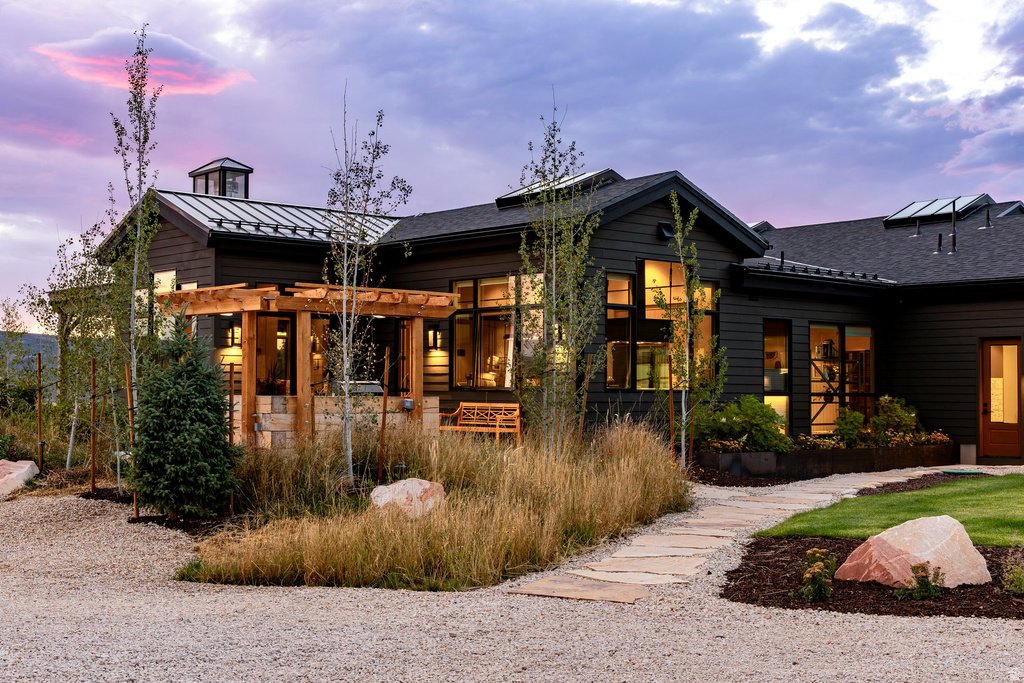 Contemporary dark-paneled exterior with extensive window placements
