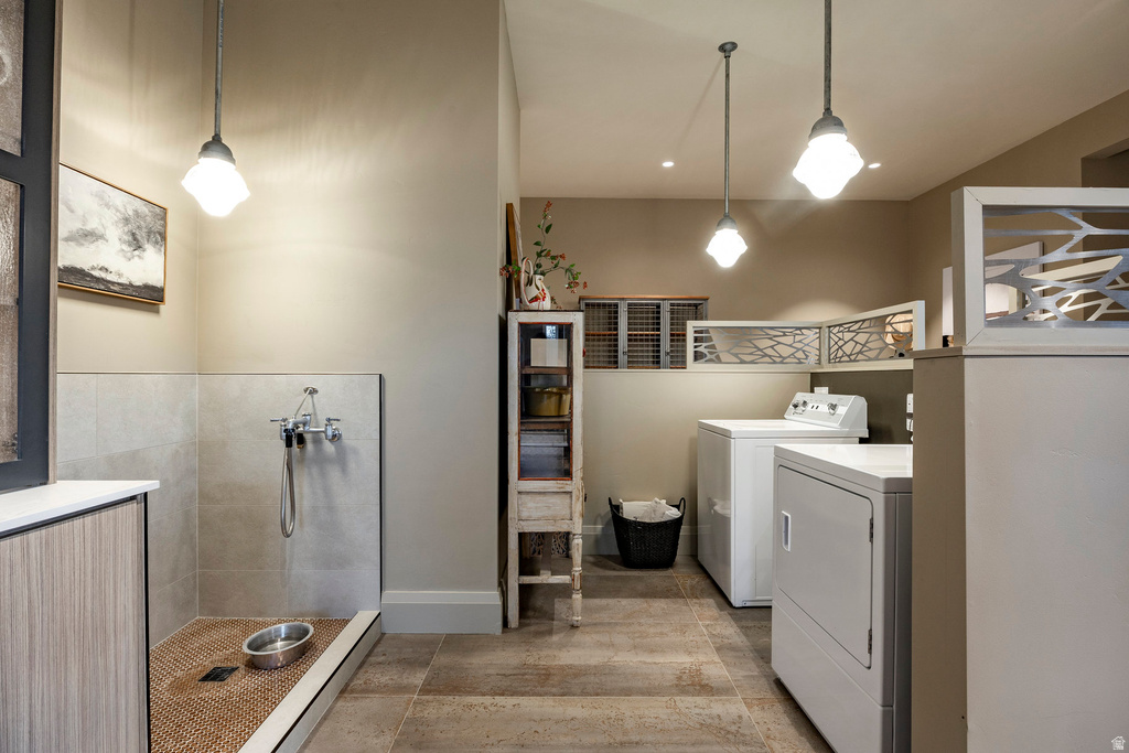 Dedicated utility room featuring a tiled pet washing station with wall-mounted fixtures