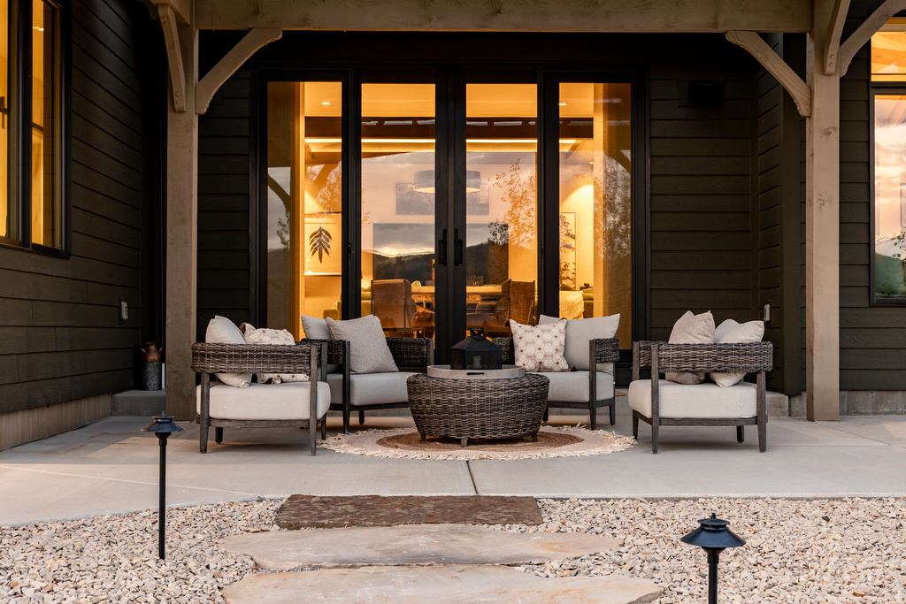 Patio featuring a concrete surface, gravel hardscaping, and large stone pavers