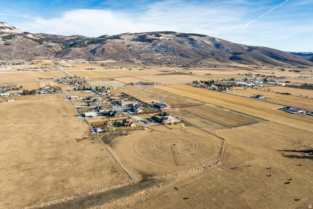 Expansive undeveloped land surrounded by established residential properties and agricultural fields