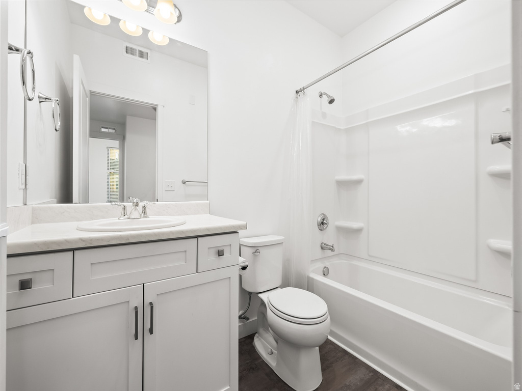 Bathroom featuring a white vanity with panel cabinetry and a light-toned countertop