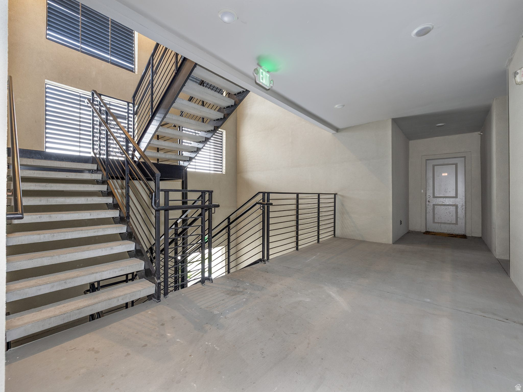 Industrial-style staircase featuring metal railings and concrete treads