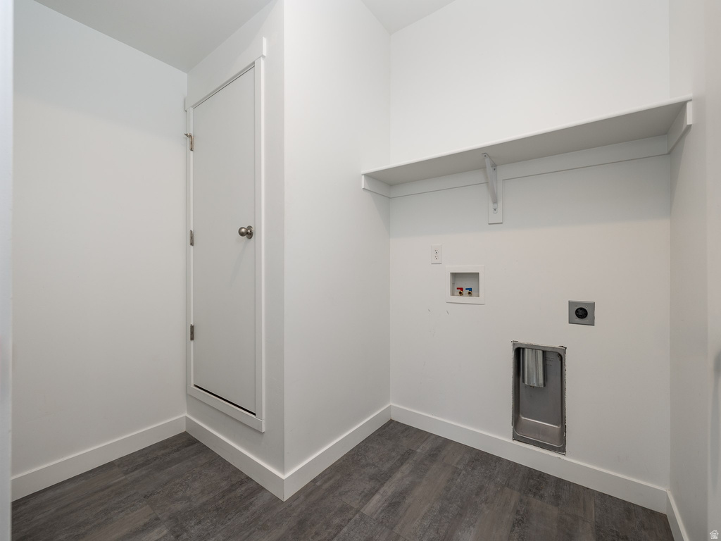 Dedicated laundry area featuring a built-in shelf, plumbing hookups, and wood-finish flooring