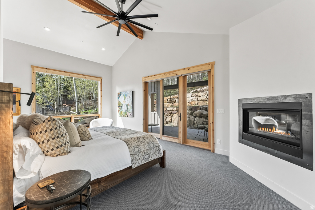 Vaulted ceilings with exposed wood beams and a large ceiling fan